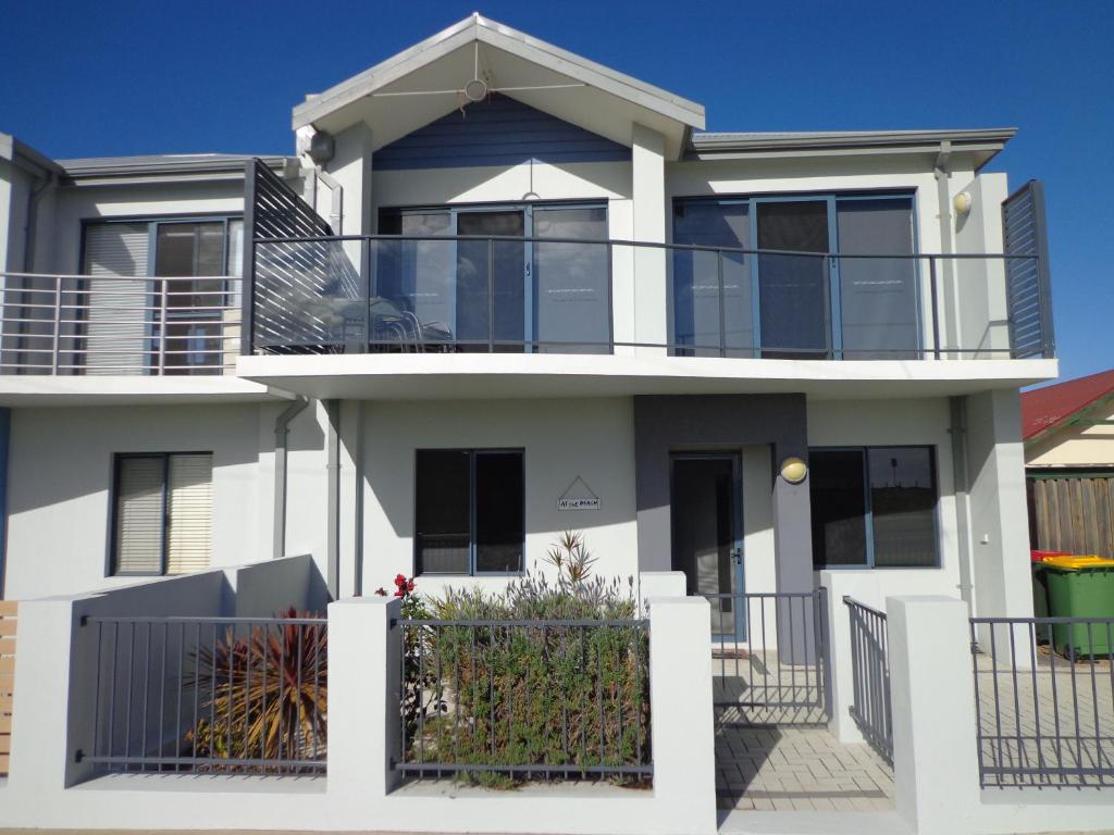 a large white house with a balcony at The Beach Villa Bunbury in Bunbury
