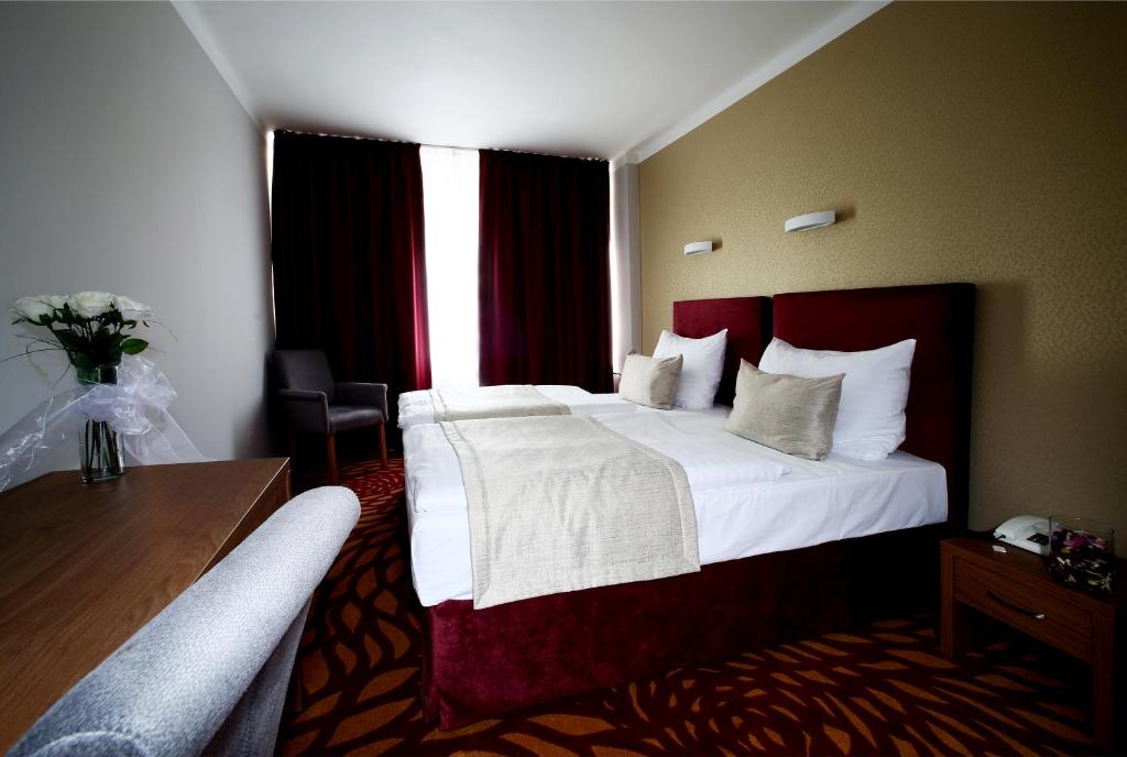Postel nebo postele na pokoji v ubytování Hotel Central