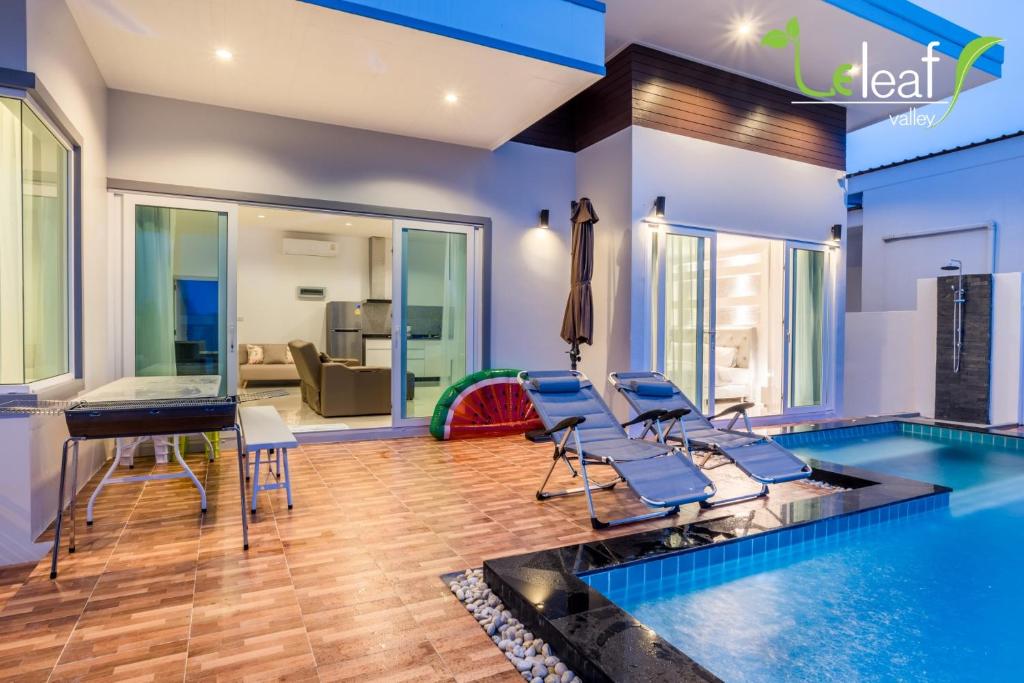 a home gym with a lap pool and chairs at Le Leaf Valley Hua Hin 29 in Hua Hin