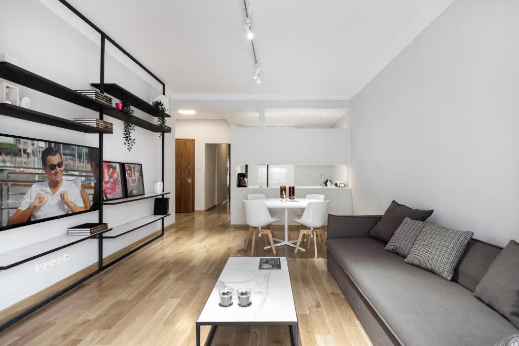 a living room with a couch and a tv at Kolonaki Square Apartment in Athens