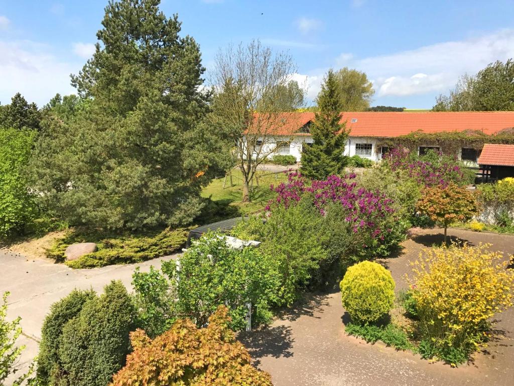 einen Garten vor einem Haus mit Büschen in der Unterkunft Landpension Dubnitz - Ferienwohnung 1 in Sassnitz