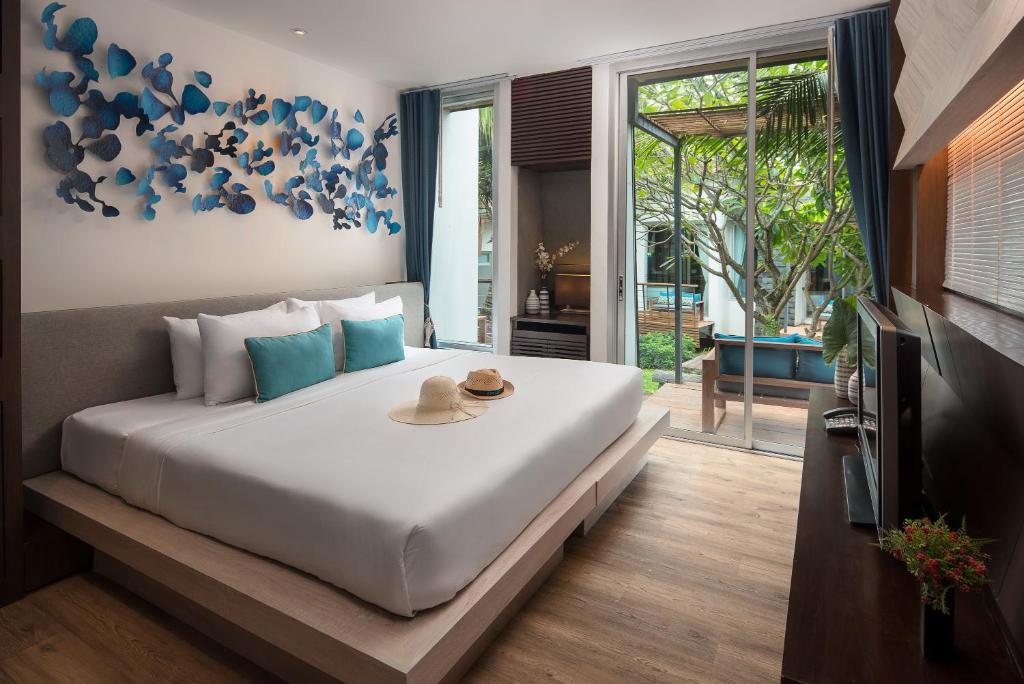a bedroom with a large white bed with hats on it at Idyllic Concept Resort in Ko Lipe