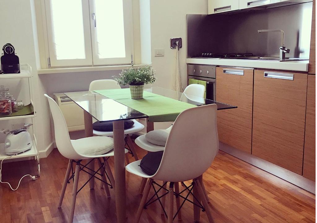 a kitchen with a table and chairs and a television at D@HOME in Rome
