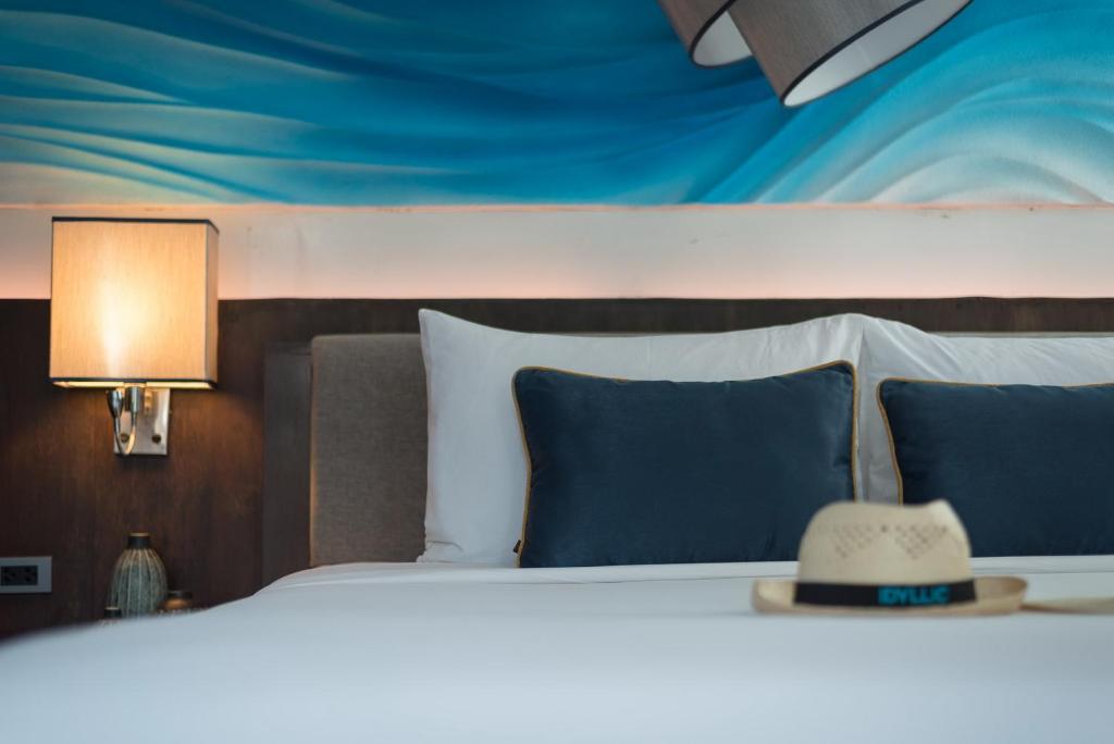 a bed with a hat sitting on top of it at Idyllic Concept Resort in Ko Lipe