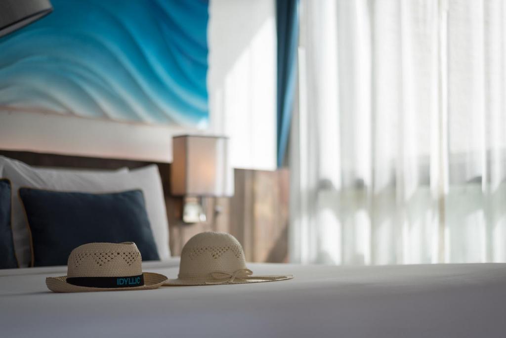 two hats sitting on a table in a hotel room at Idyllic Concept Resort in Ko Lipe