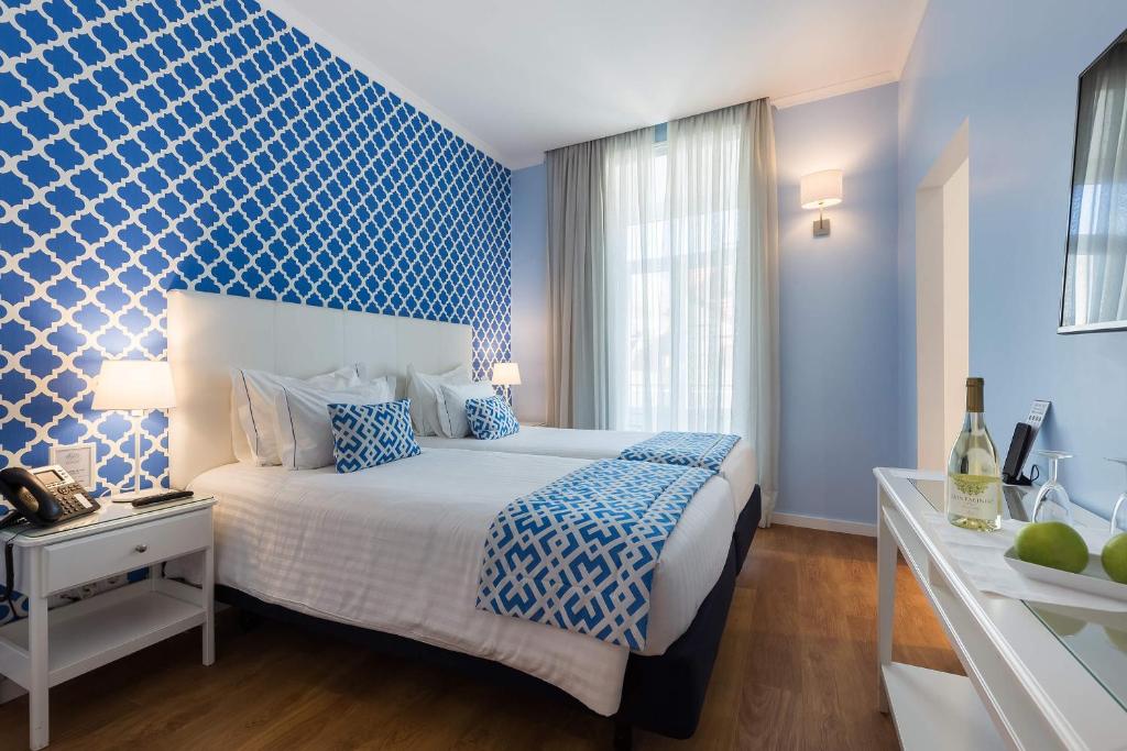 a bedroom with a bed and a blue wall at Dream Chiado Apartments in Lisbon