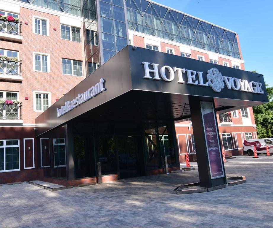 a hotel sign in front of a building at Hotel Voyage in Belgorod