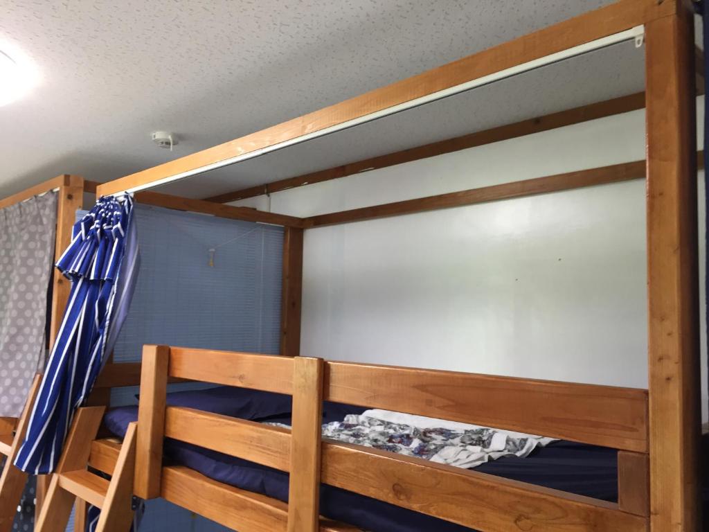 a bunk bed in a room with blue walls at Shimaotoya in Iriomote