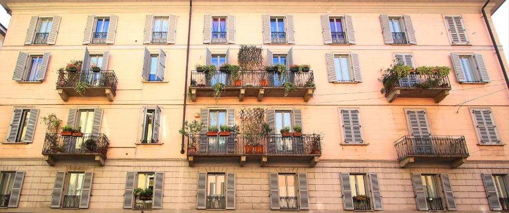 un bâtiment avec des balcons et des plantes en pot dans l'établissement Residenza Porta Romana, à Milan