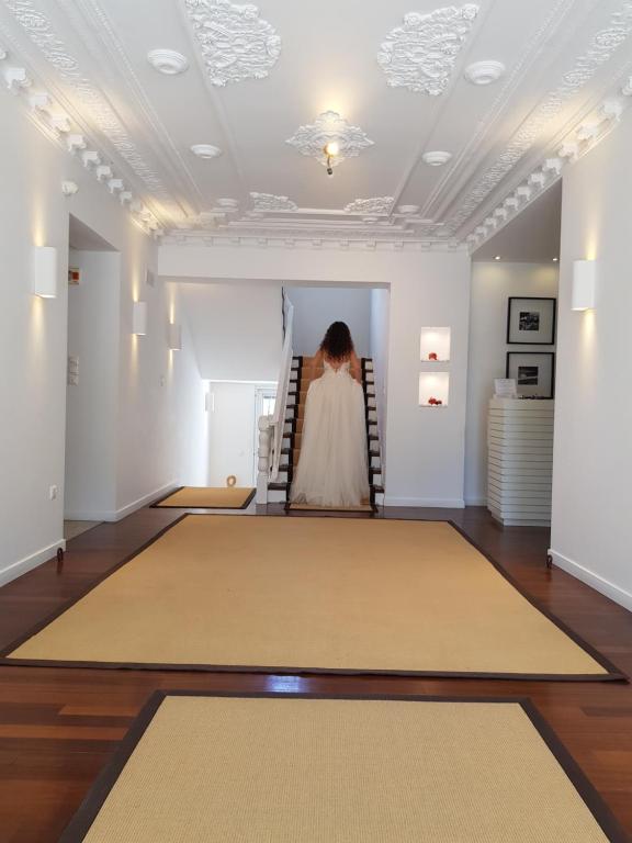 a woman is sitting on the stairs in an art gallery at Apollon Boutique Hotel in Parikia