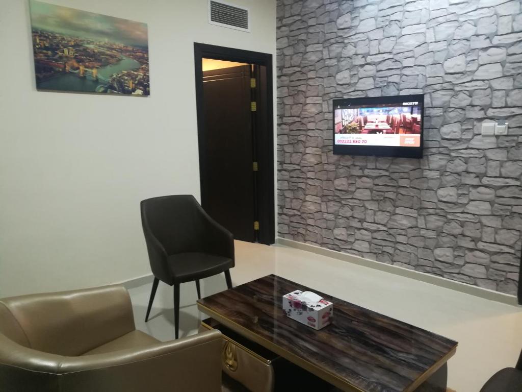 TV a/nebo společenská místnost v ubytování Tanuf Residency Hotel