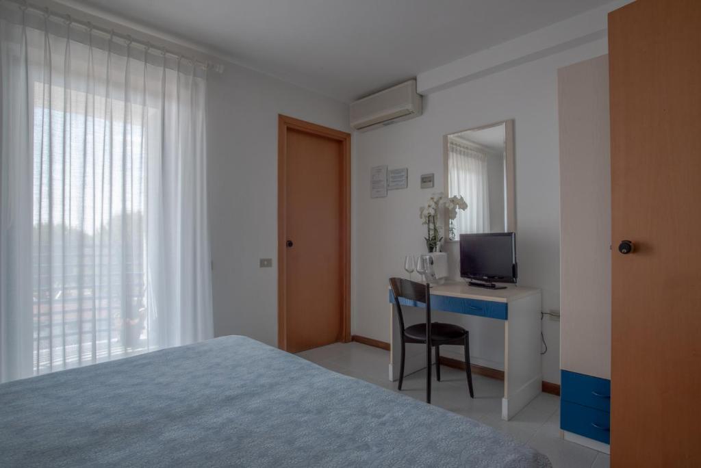 Postel nebo postele na pokoji v ubytování Hotel Sirenetta