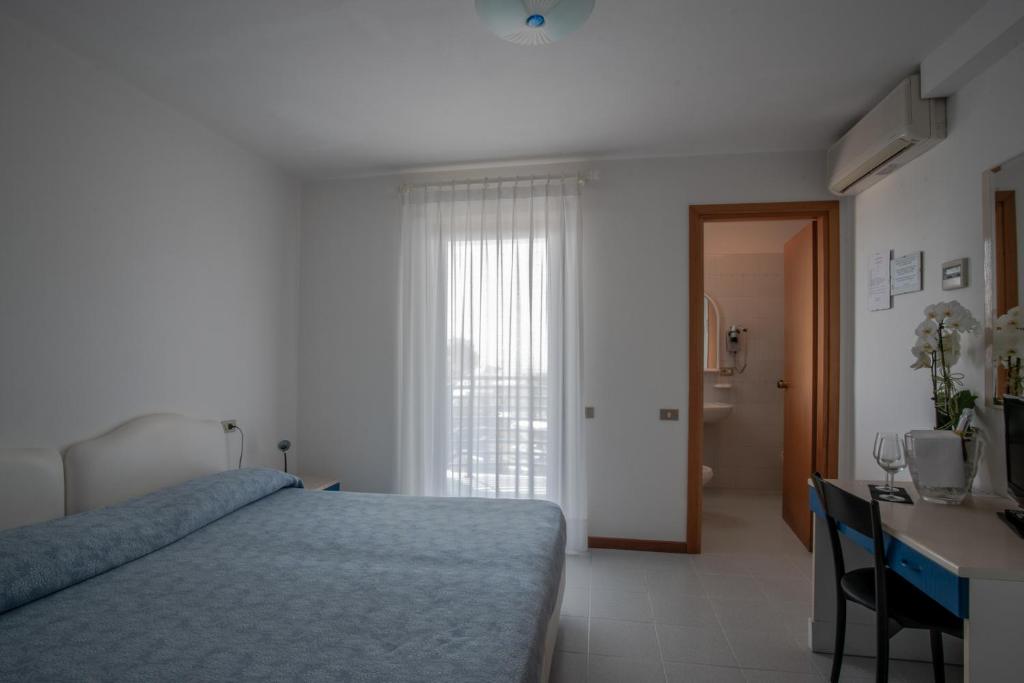 Postel nebo postele na pokoji v ubytování Hotel Sirenetta