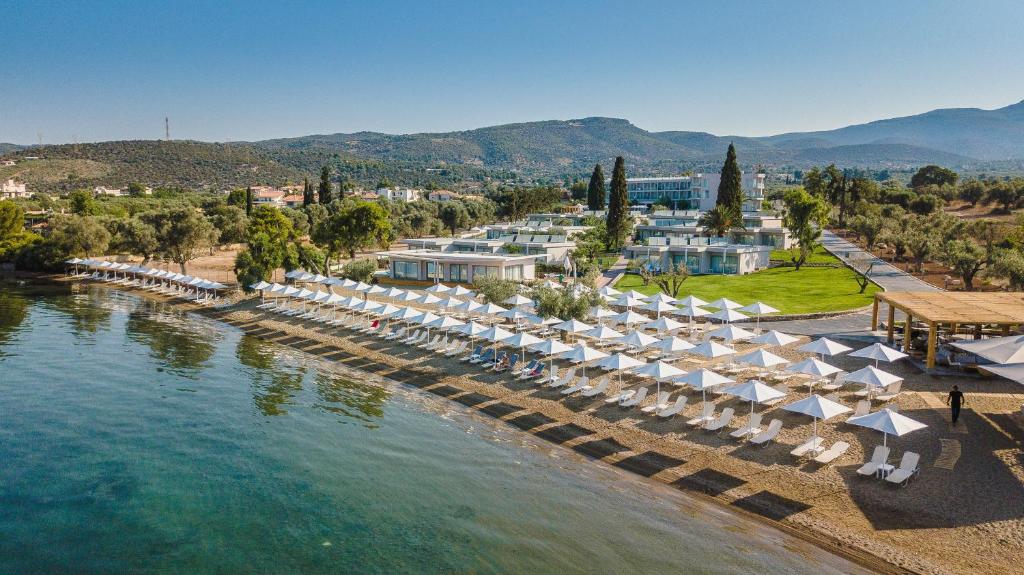 an aerial view of a resort with chairs and umbrellas at Amaronda Resort & Spa Eretria in Eretria