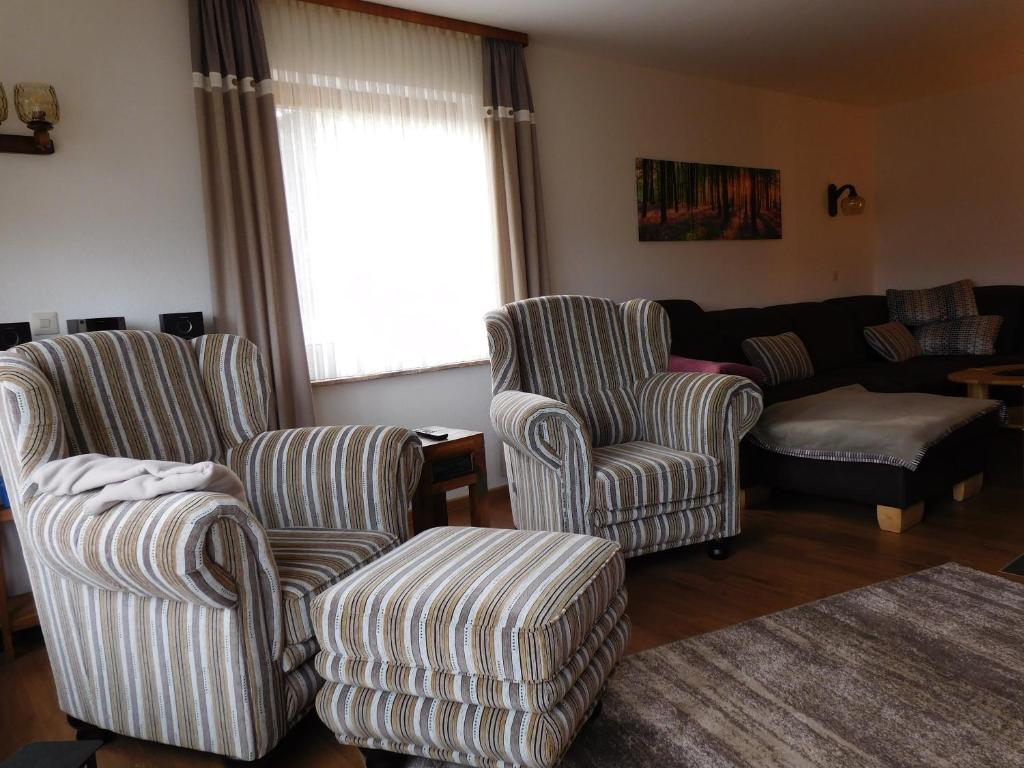 a living room with two chairs and a couch at Ferienhaus Rabenhorst in Bad Berleburg