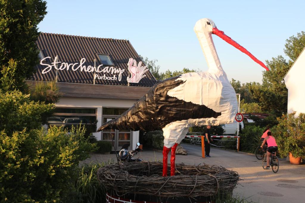 a large statue of a bird in front of a building at Storchencamp Gästehaus Purbach in Purbach am Neusiedlersee