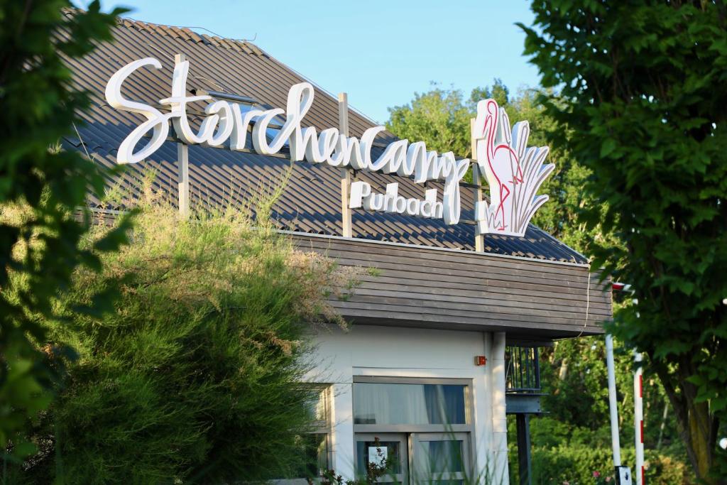 a sign on the roof of a restaurant at Storchencamp Gästehaus Purbach in Purbach am Neusiedlersee