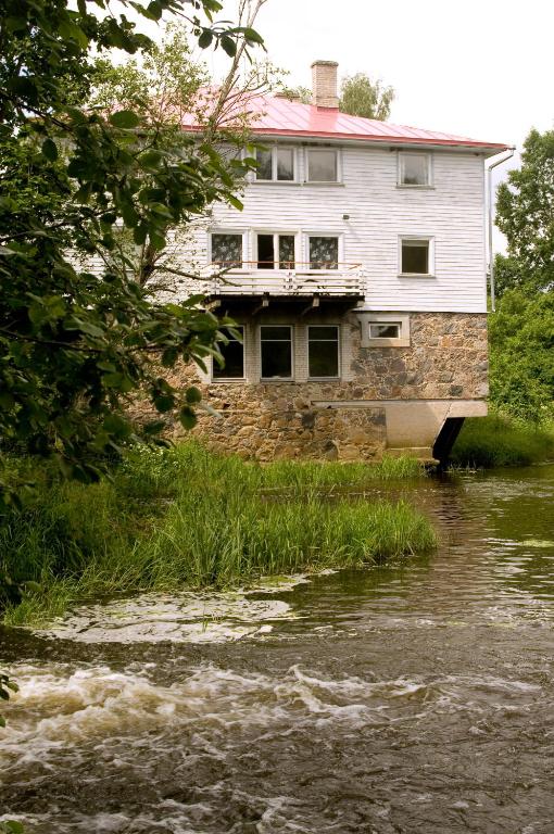 a house sitting on the side of a river at Mosina Vesiveski in Vissi