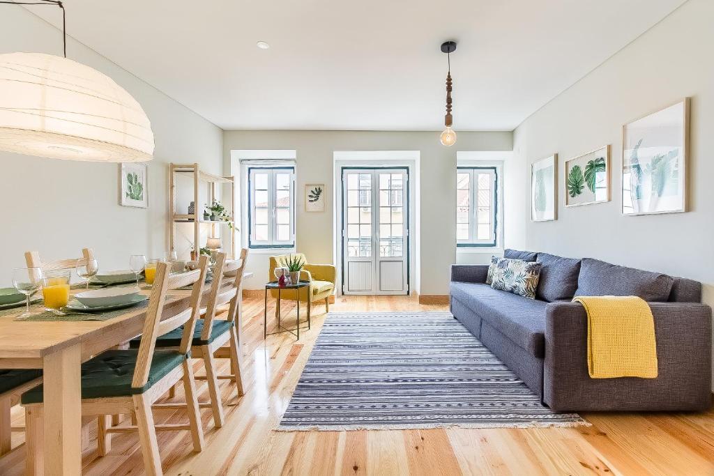 a living room with a couch and a table at Santos Green Apartment in Lisbon