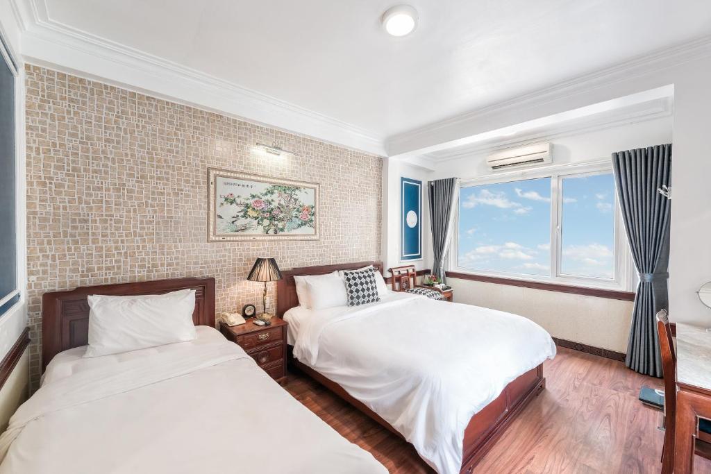 Postel nebo postele na pokoji v ubytování Prince II Hotel