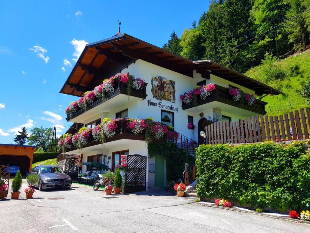 ein weißes Gebäude mit Blumenkästen drauf in der Unterkunft Haus Bodenwinkler in Gröbming