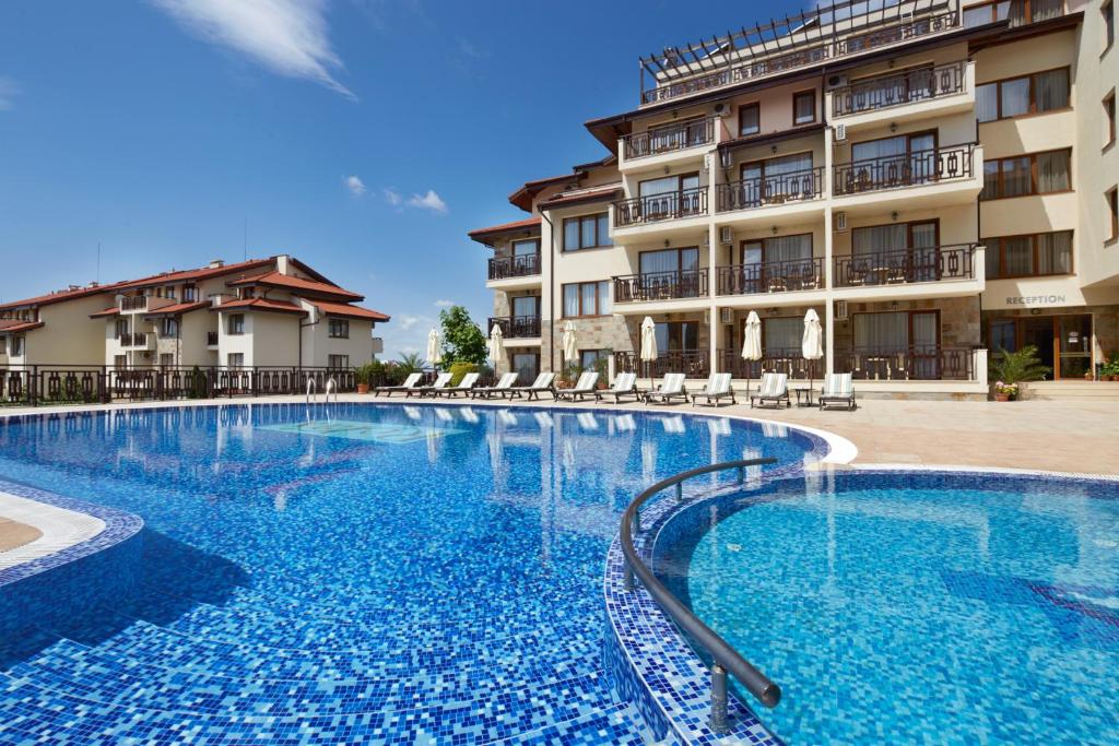 a large swimming pool in front of a building at Relax Holiday Complex & Spa in Sunny Beach