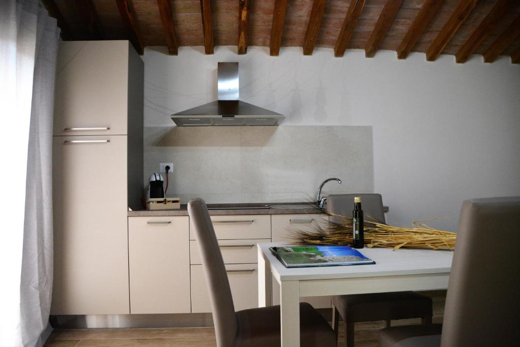 a kitchen with a table and a stove top oven at Agriturismo L'Aquilone in Magliano in Toscana