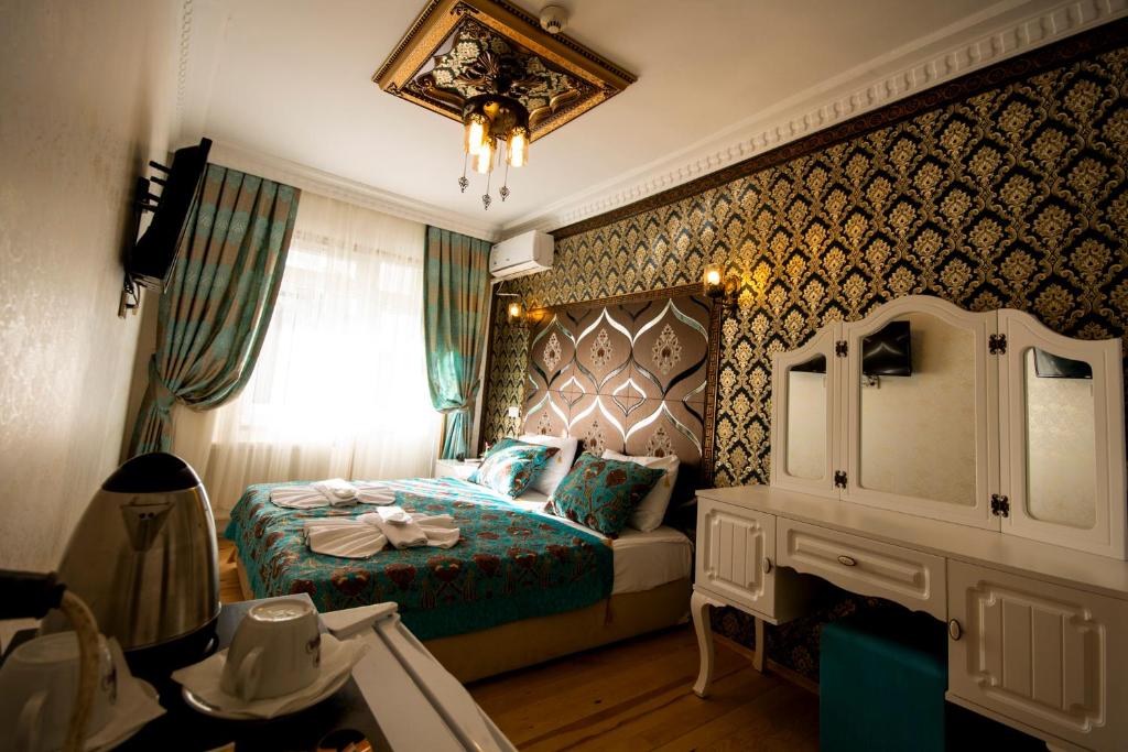 a bedroom with a bed and a dresser in it at Paris Garden Hotel Istanbul in Istanbul