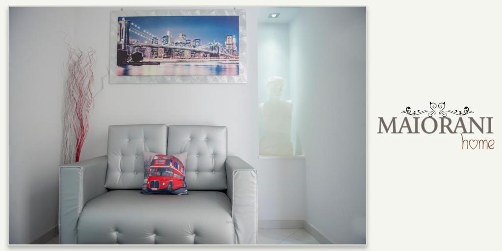 a chair in a room with a picture of a bridge at Maiorani Home in Naples