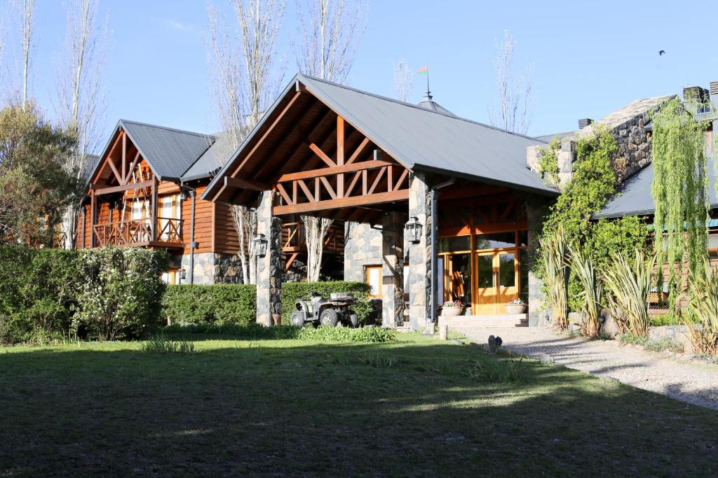 a large house with a gambrel roof at Chamonix Posada & Spa Habitaciones dentro de la posada o Loft con hidromasaje y apartamentos a 300 mts de la posada in Villa General Belgrano