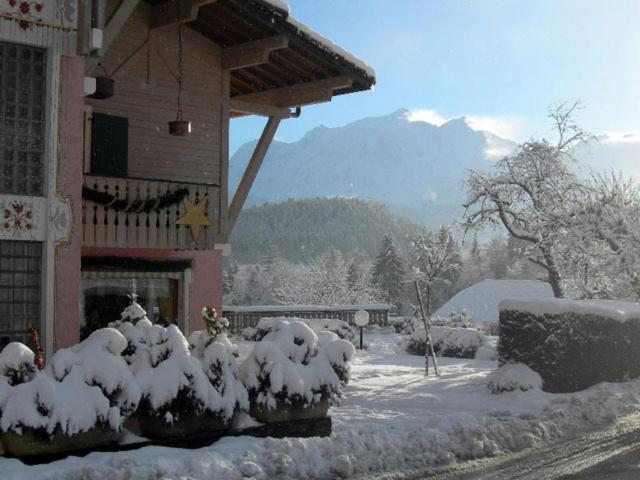 a building with snow covered bushes in front of it at Le Cordonant in Cordon