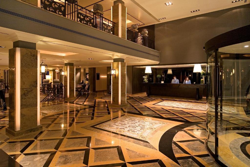 a lobby of a hotel with a floor of tiles at Grande Real Villa Itália Hotel & Spa in Cascais