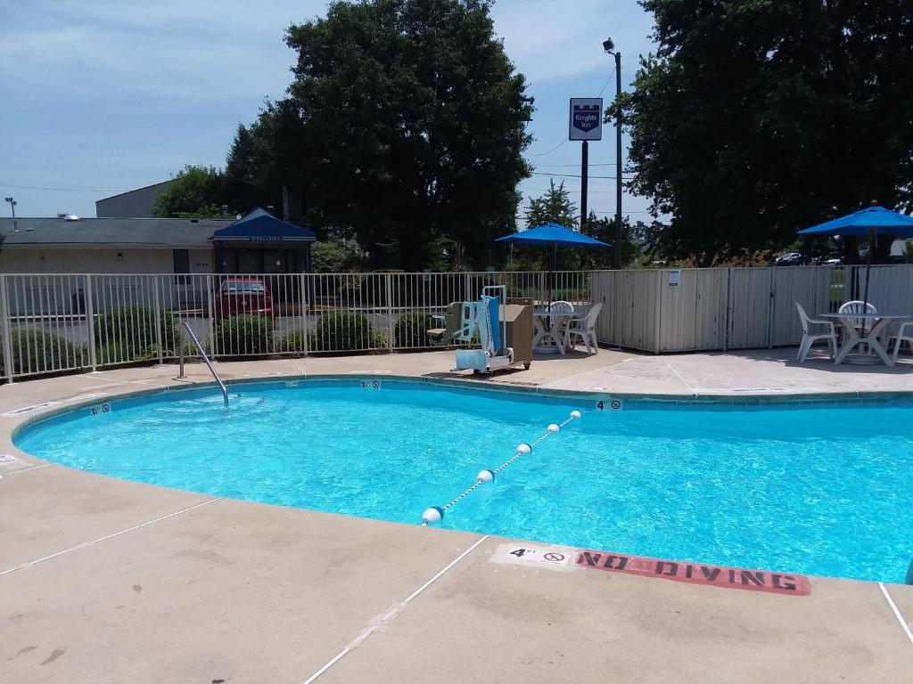 a large swimming pool with blue water at Knights Inn Burlington NC in Burlington