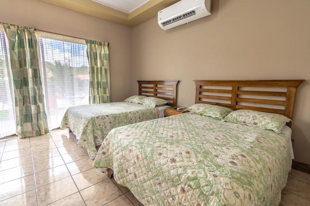 Postel nebo postele na pokoji v ubytování Hotel Pacuare