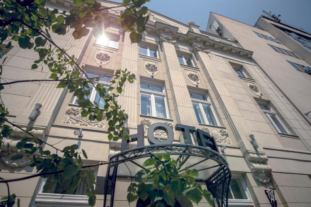 a building with a gate in front of it at Public House Hotel in Belgrade