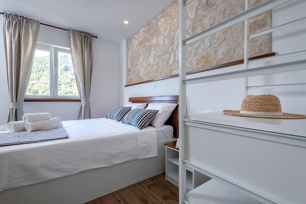 a bedroom with a bed and a window at King's Landing - Hvar in Hvar
