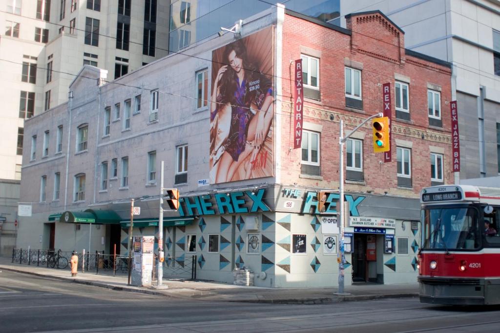 a bus is parked in front of a building at The Rex Hotel Jazz & Blues Bar in Toronto