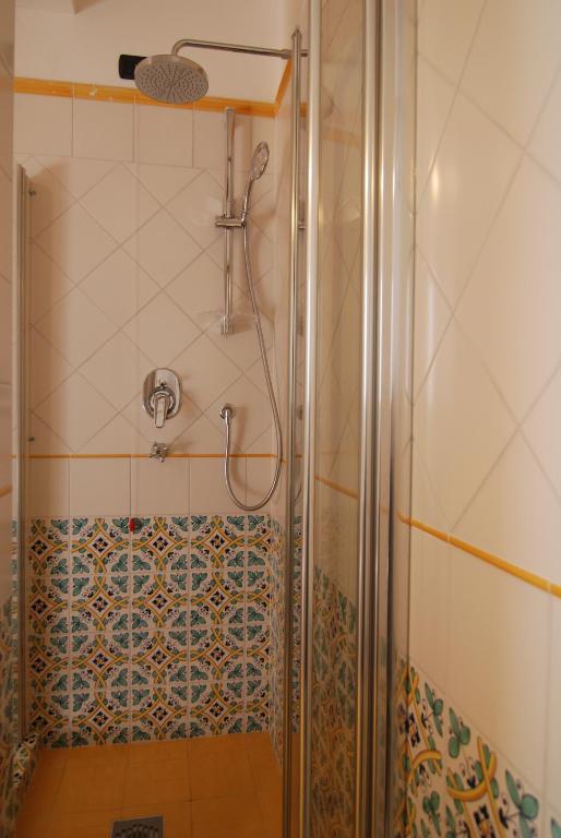 a shower with a glass door in a bathroom at Bella Baia Relais in Maiori