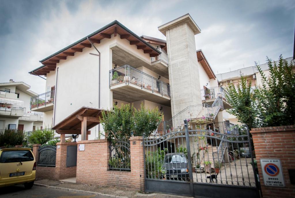 a building with a fence in front of it at Magnolia B&B in Silvi Marina