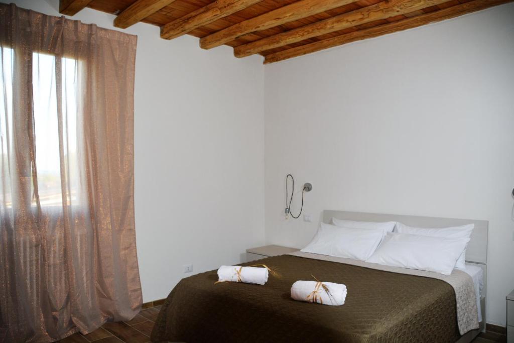 Postel nebo postele na pokoji v ubytování Agriturismo L'Aquilone