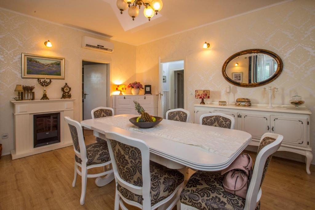 a dining room with a white table and chairs at Apartment Valerija in Jesenice