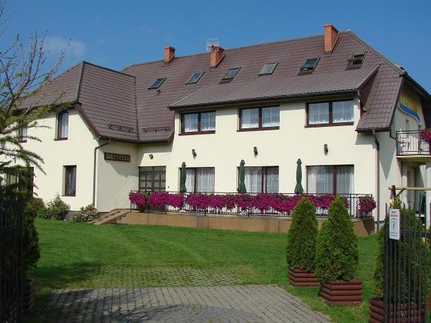 a large white house with a roof at D.W. KRYSTYNA in Dębki