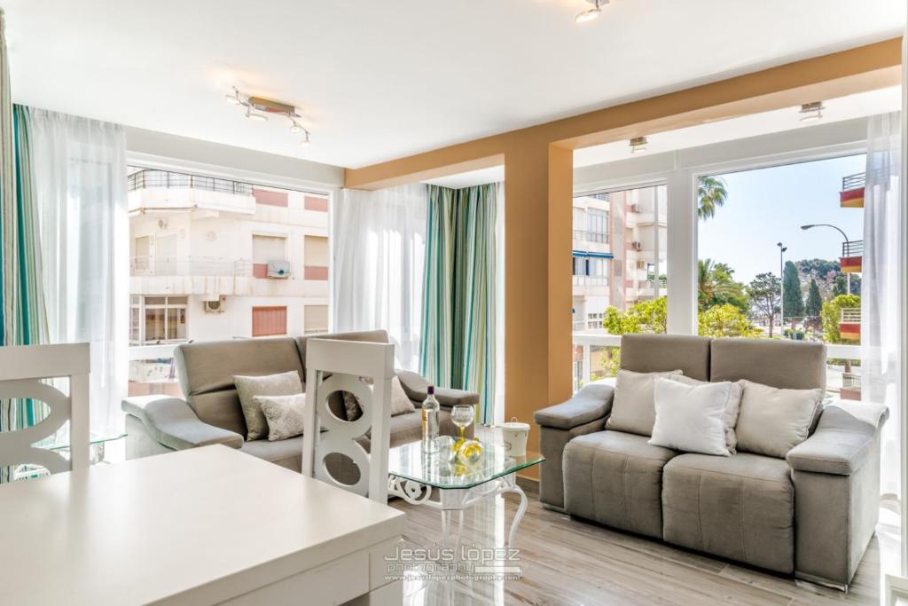 a living room with two couches and a table at Junto al mar in Torre del Mar