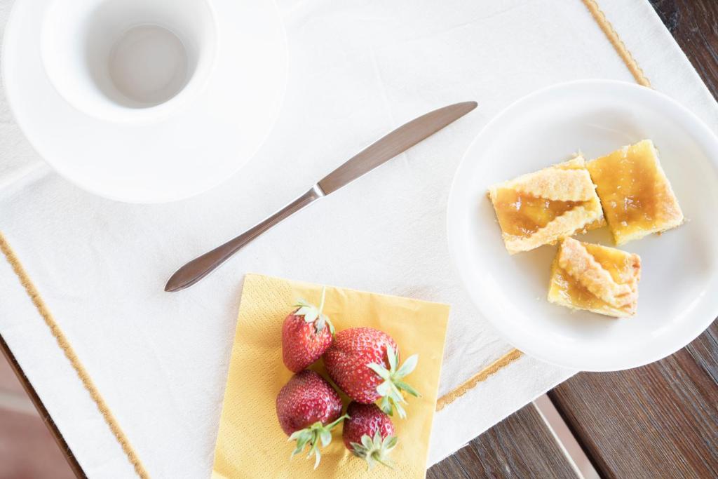 a plate of food with strawberries on a table at Agriturismo Lucerna del Lago Prile in Castiglione della Pescaia