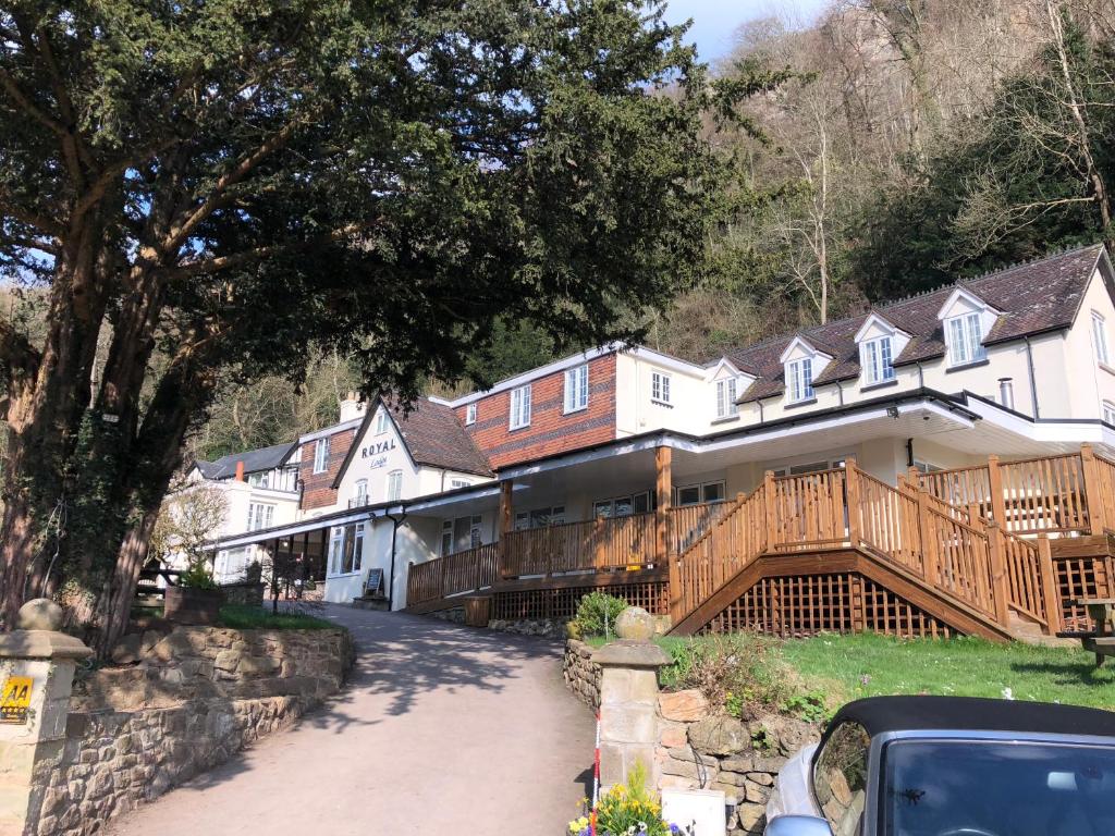 a large house with a porch and a deck at Royal Lodge in Symonds Yat