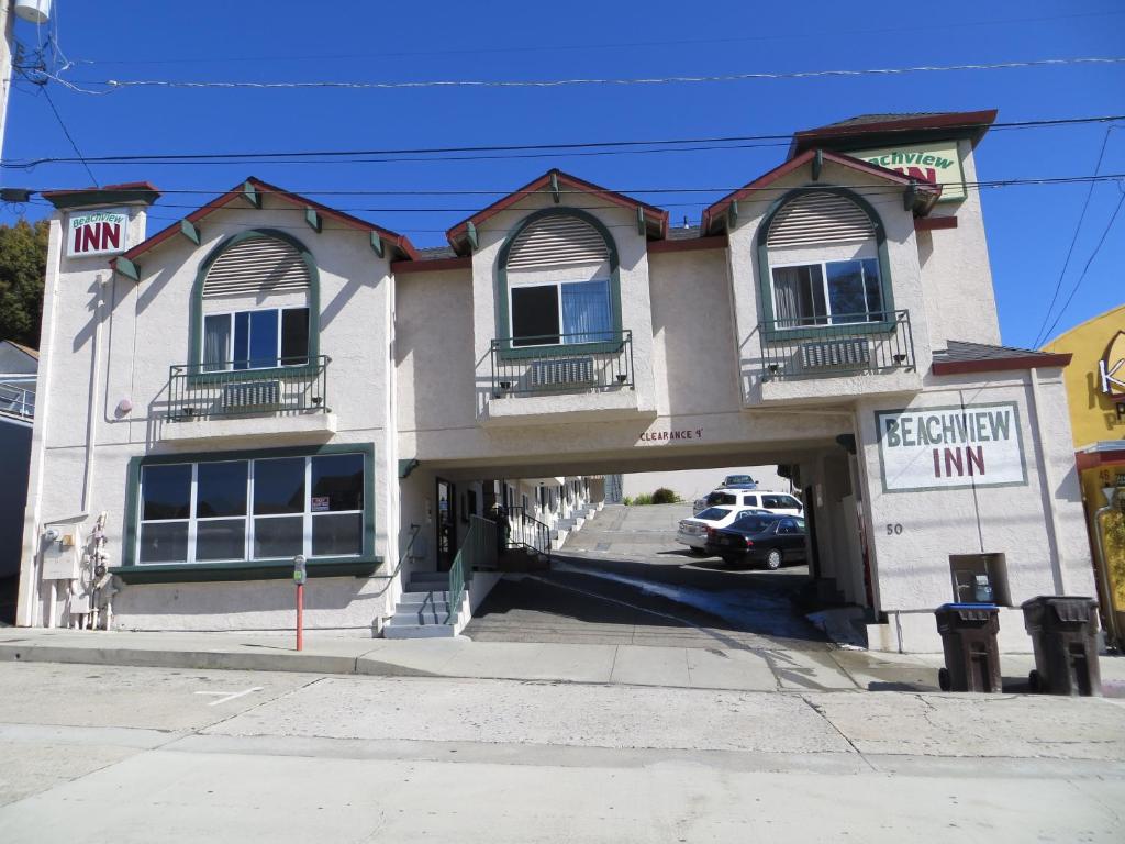 a building with a car parked in front of it at Beachview Inn in Santa Cruz