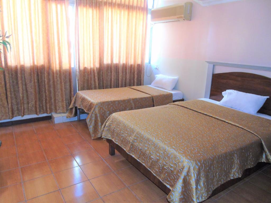 Postel nebo postele na pokoji v ubytování Hotel Malecon Inn