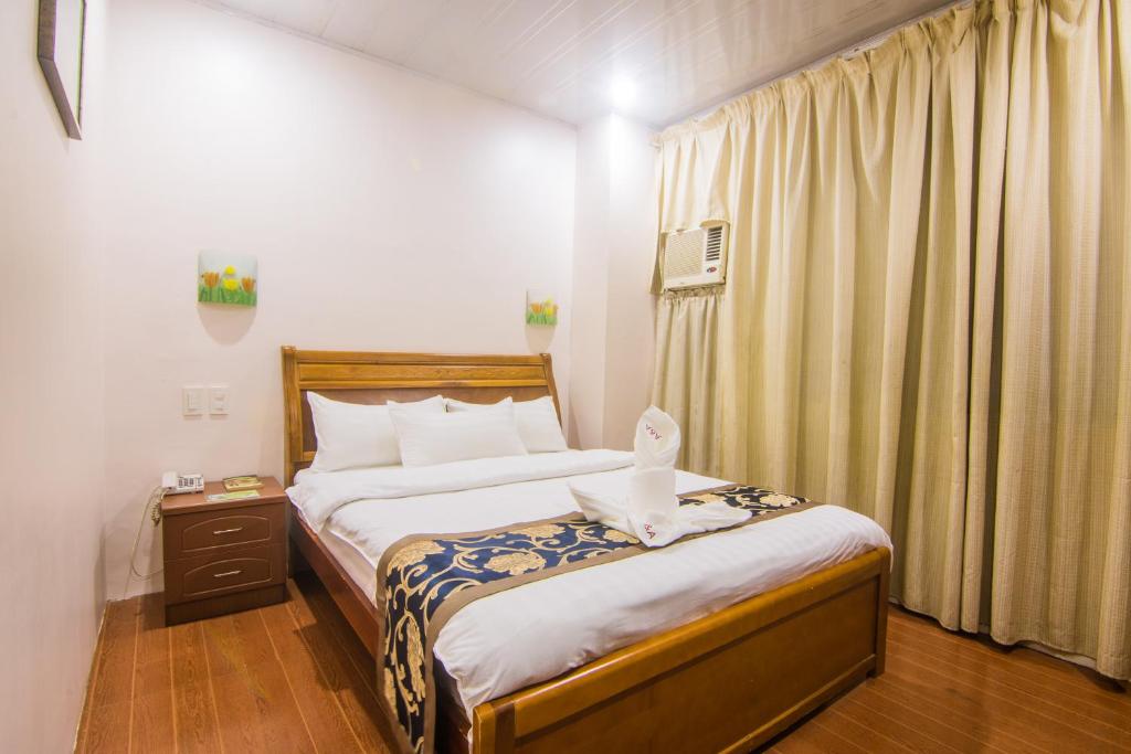 Postel nebo postele na pokoji v ubytování A&A Plaza Hotel