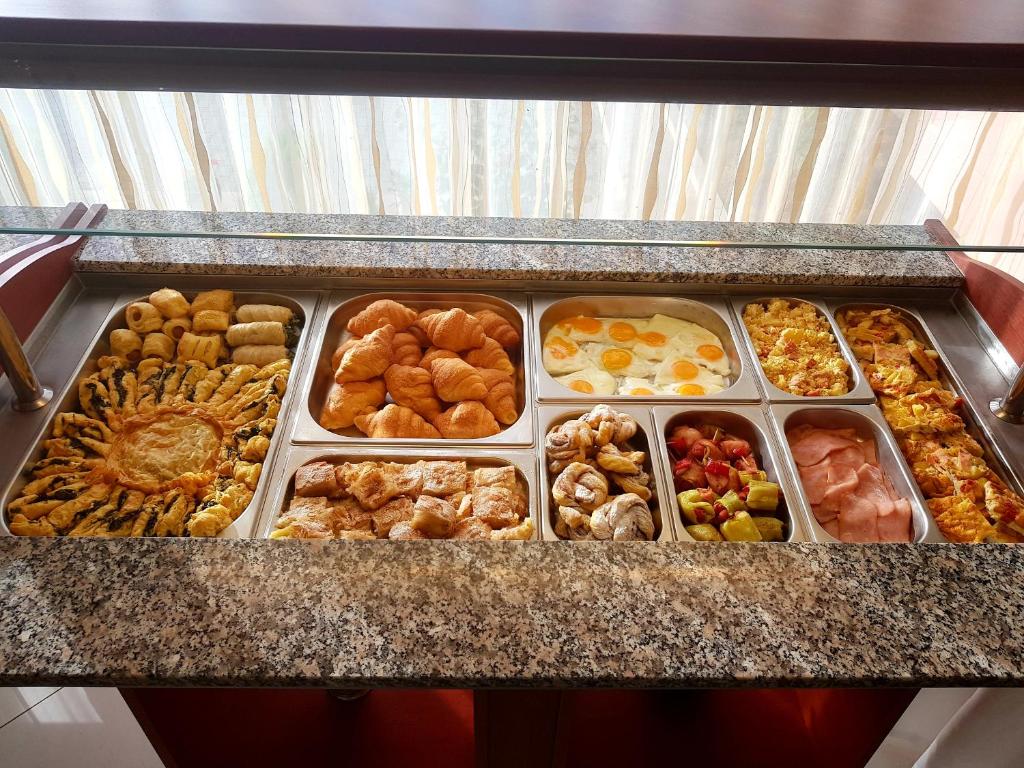 a tray of different types of pastries on a counter at Hotel Diamond in Limenaria