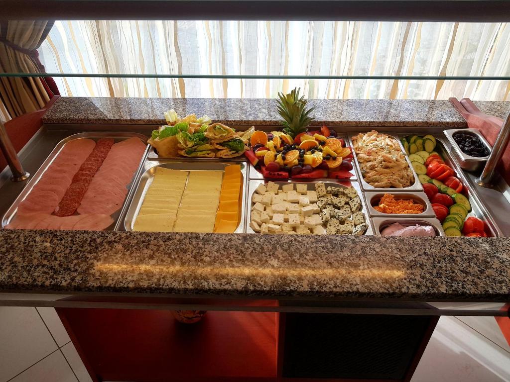 a buffet with different types of food on a counter at Hotel Diamond in Limenaria